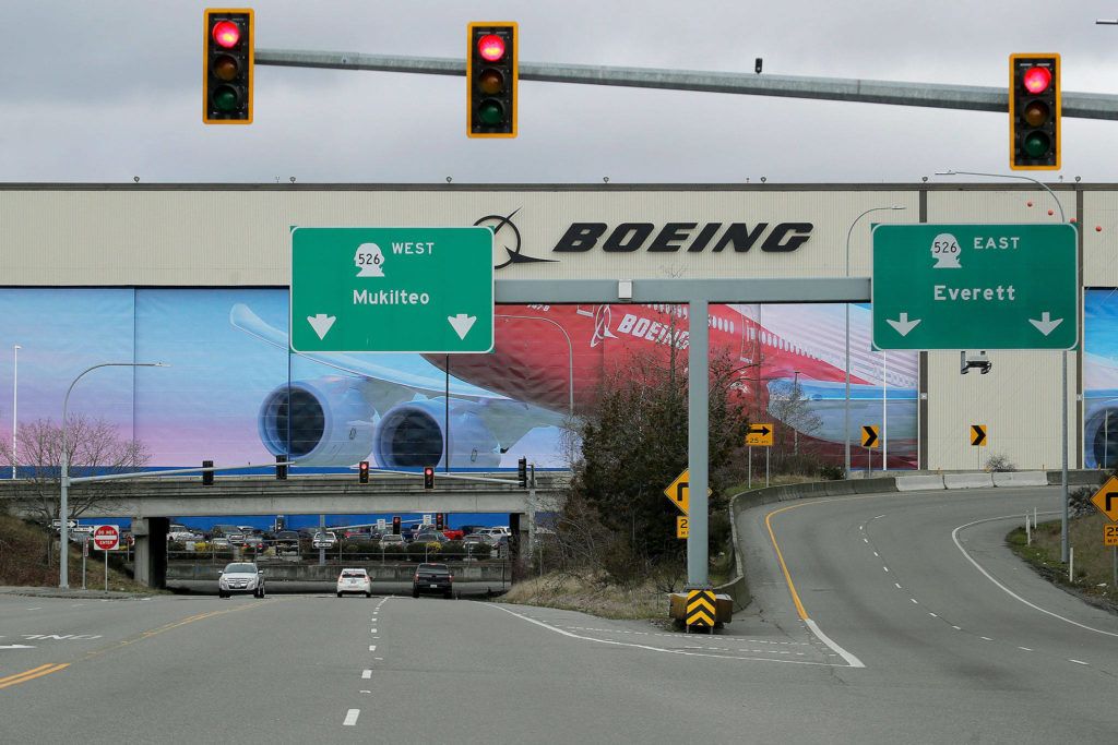 Cars drive near Boeing’s manufacturing facility in Everett on March 23 north of Seattle. (AP Photo/Ted S. Warren)
