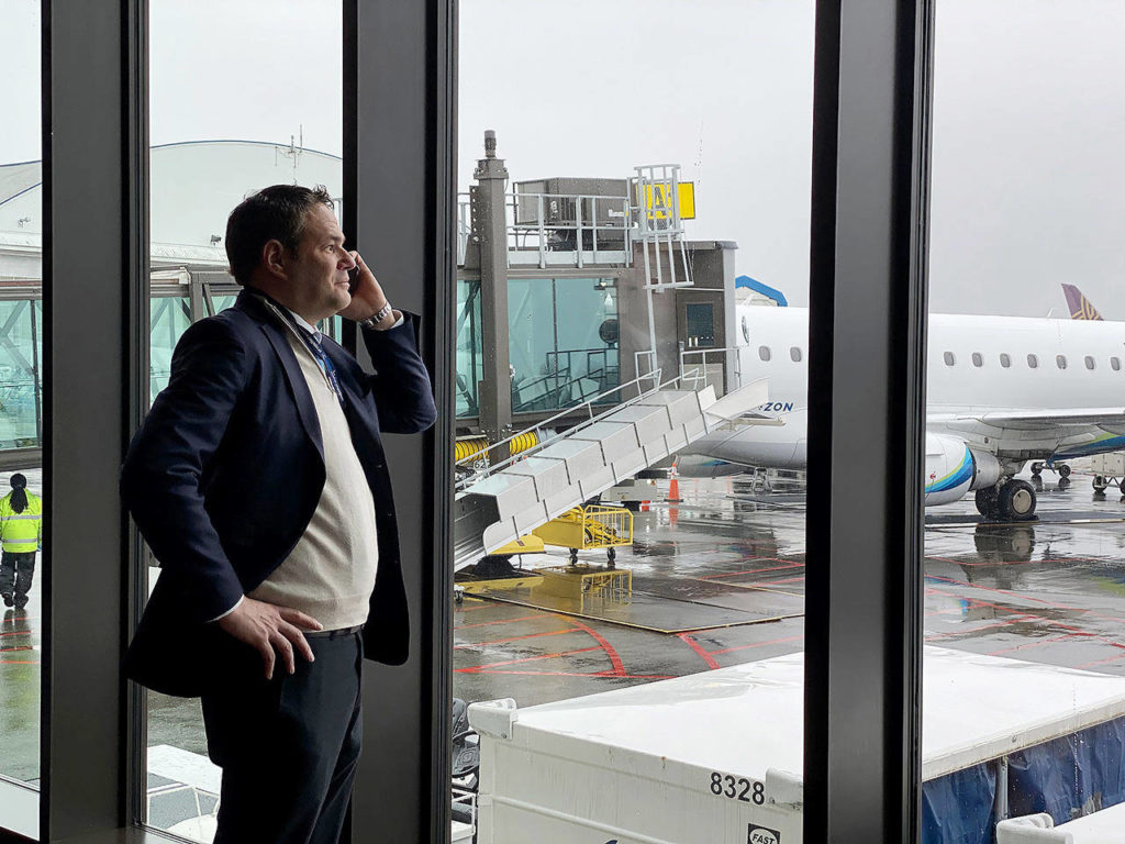 Brett Smith, CEO of Propeller Airports, takes a call March 2 inside the Paine Field terminal. (Sue Misao / The Herald)
