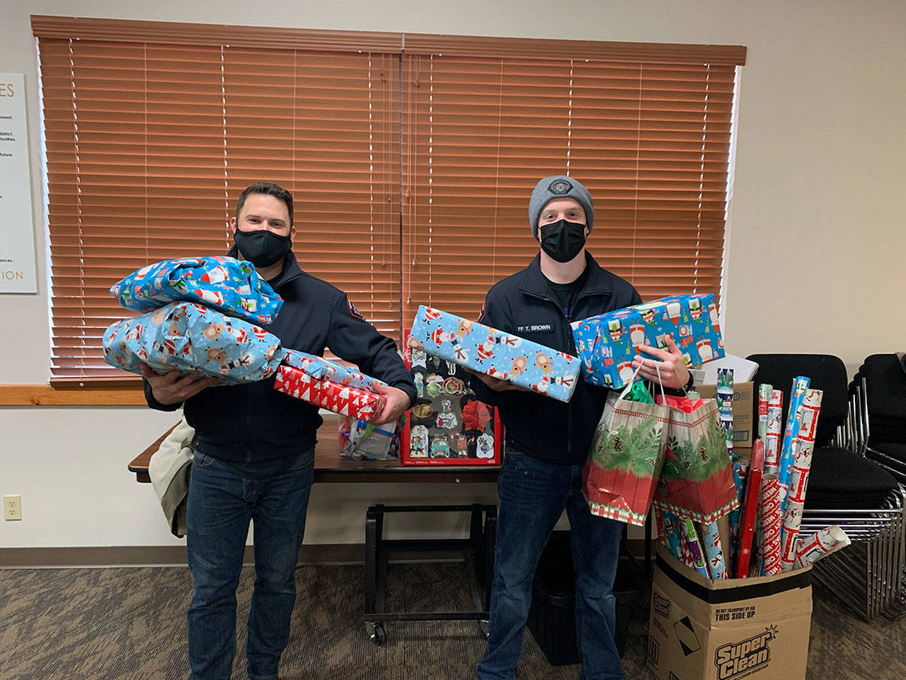 Firefighters deliver gifts to families in need. (Snohomish Regional Fire Rescue)