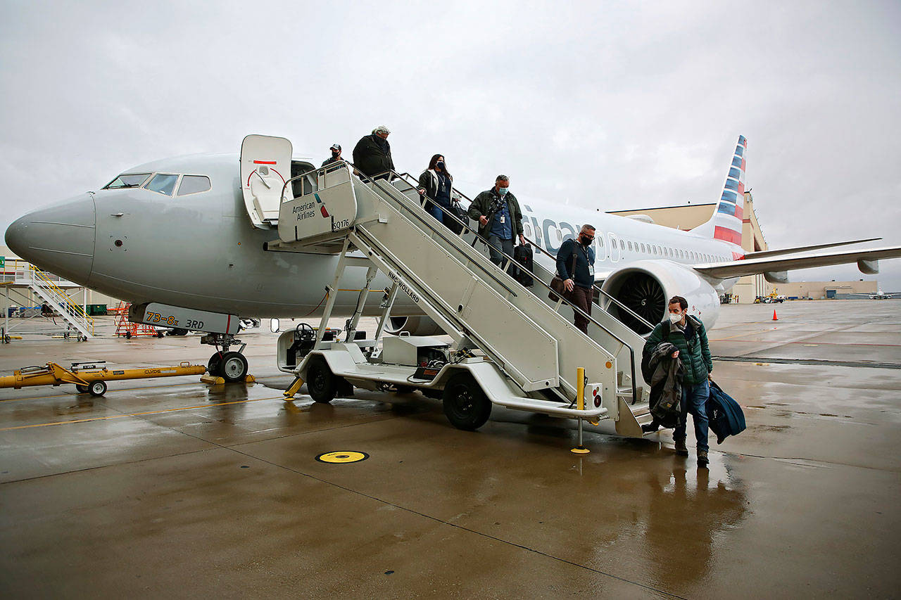 Journalists and American Airlines employees disembark a Boeing 737 Max at the American Airlines Tulsa maintenance facility Dec. 2, 2020 in Tulsa, Okla. Earlier the plane had flown a group of journalists and American Airlines employees from Dallas to the American Airlines Tulsa maintenance facility. (Mike Simons / Tulsa World via AP)