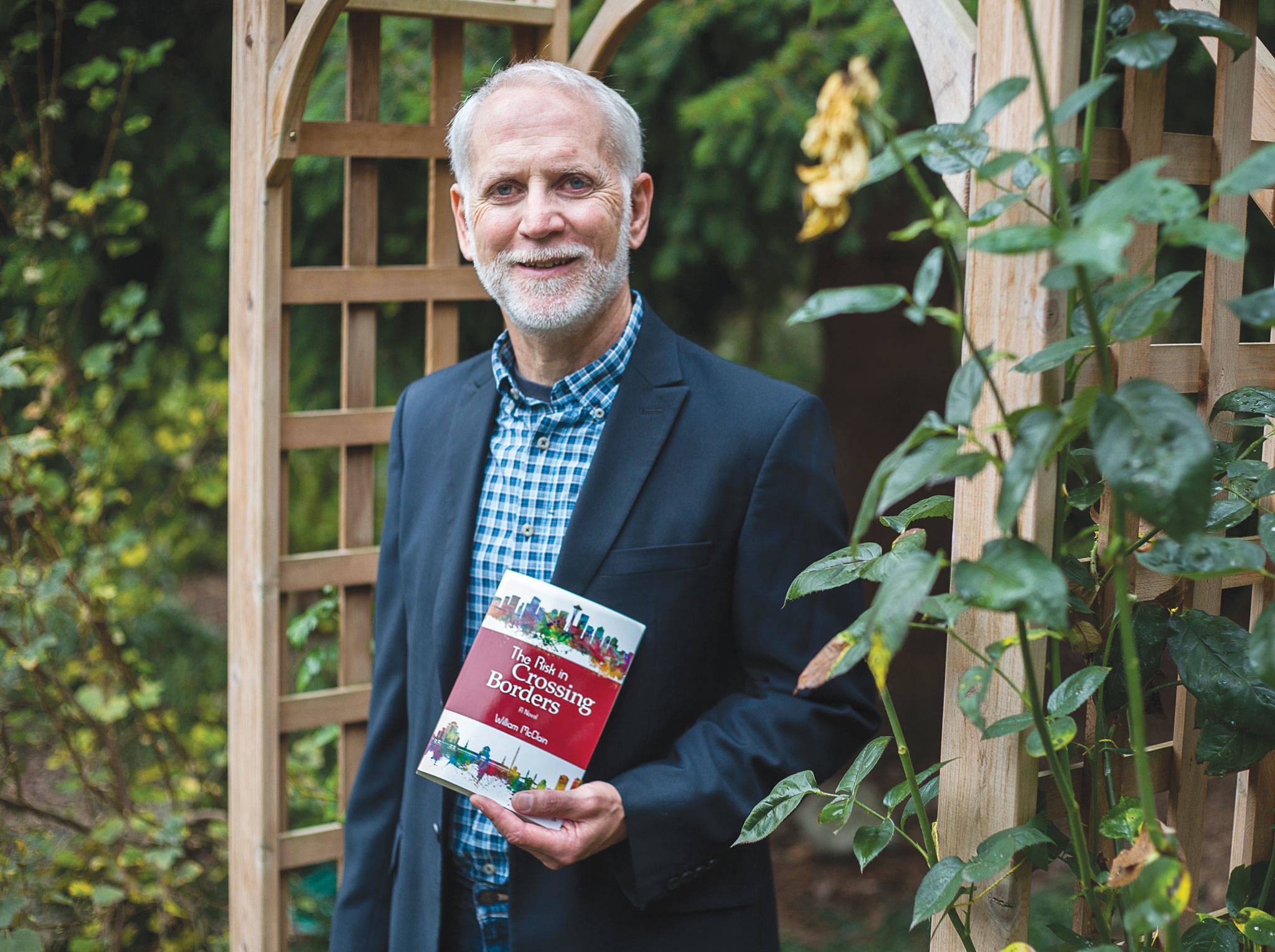 Retired teacher William McClain, of Lynnwood, has published his first novel, “The Risk in Crossing Borders.” (Olivia Vanni / The Herald)