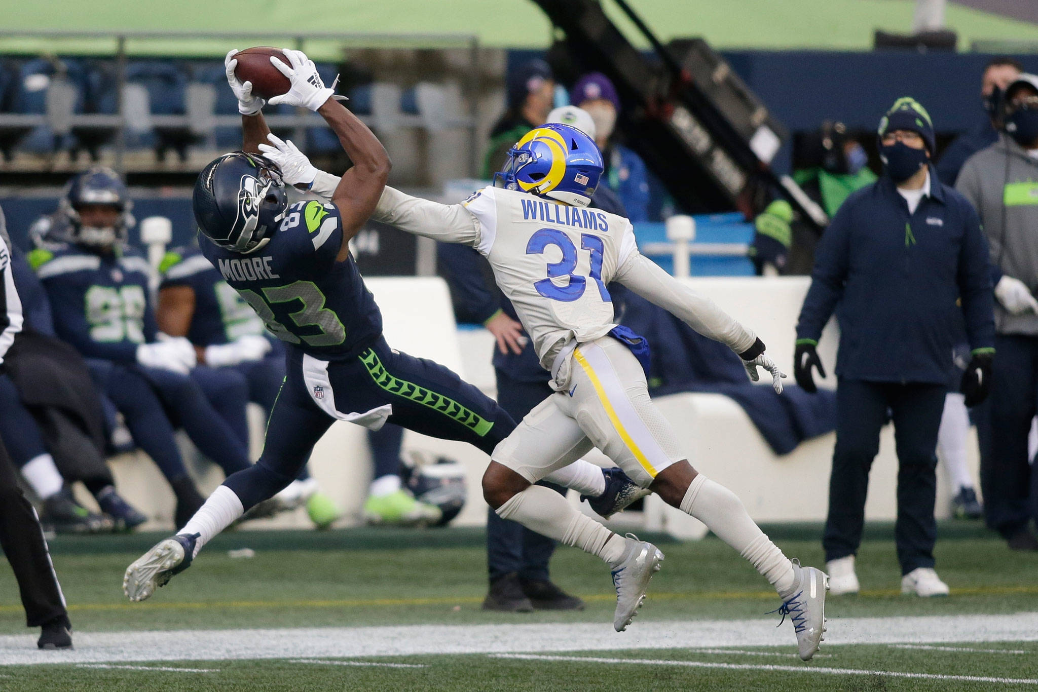 Seahawks wide receiver David Moore (left) makes a catch in front of Rams cornerback Darious Williams (31) during the second half of a game Dec. 27, 2020, in Seattle. (AP Photo/Scott Eklund)