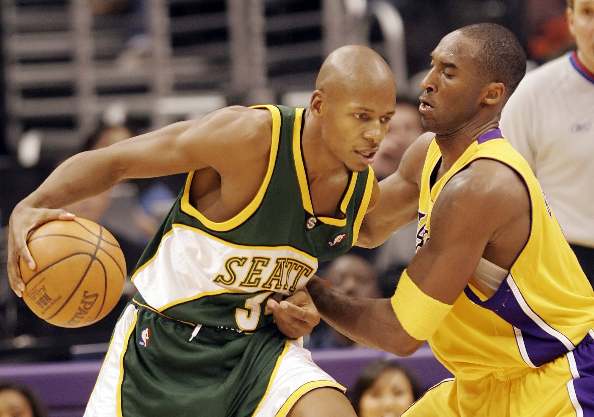 The Seattle SuperSonics’ Ray Allen, left, tries to dribble past the Los Angeles Lakers’ Kobe Bryant during a game on Nov. 24, 2005, in Los Angeles. (AP Photo/ Francis Specker)