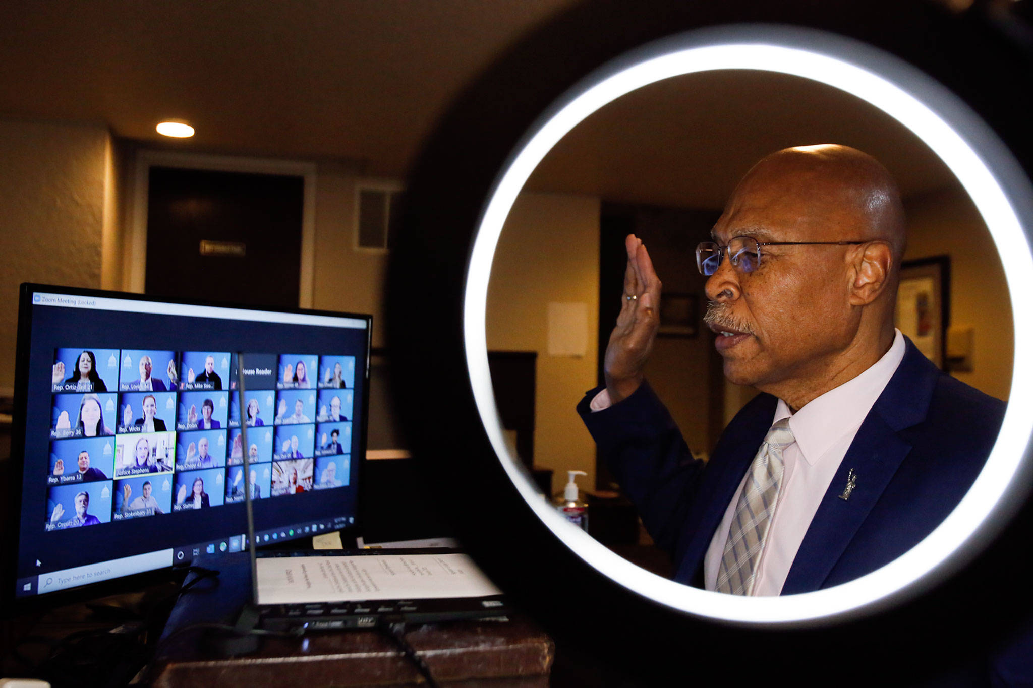 State Rep. John Lovick is sworn in at his home Friday in Mill Creek. (Kevin Clark / The Herald)