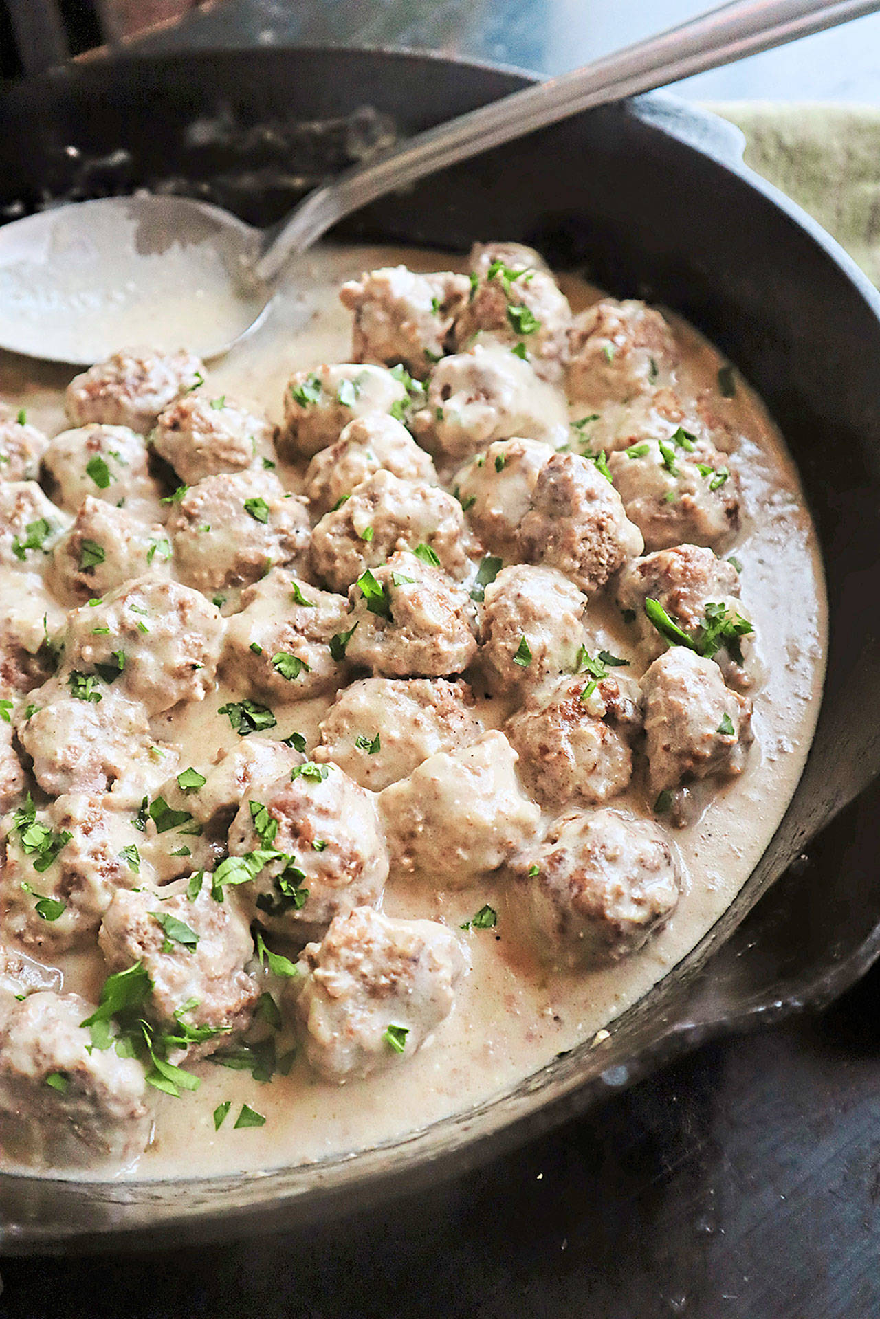 Swedish meatballs are served in a rich, roux-based gravy made with beef broth, heavy cream and sour cream. Cranberry sauce adds a bright and tangy garnish. (Gretchen McKay)