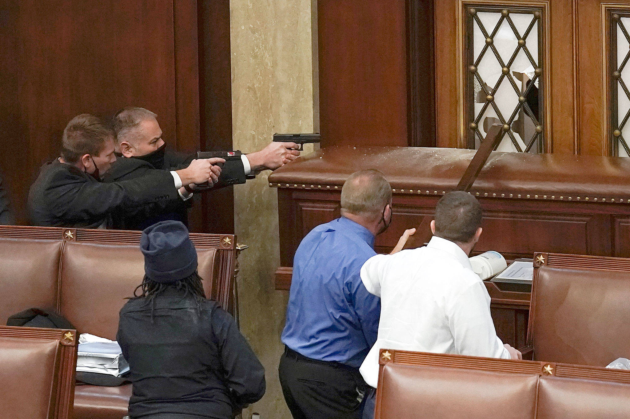 U.S. Capitol Police with guns drawn watch as protesters try to break into the House Chamber at the U.S. Capitol on Wednesday in Washington. (AP Photo/J. Scott Applewhite)