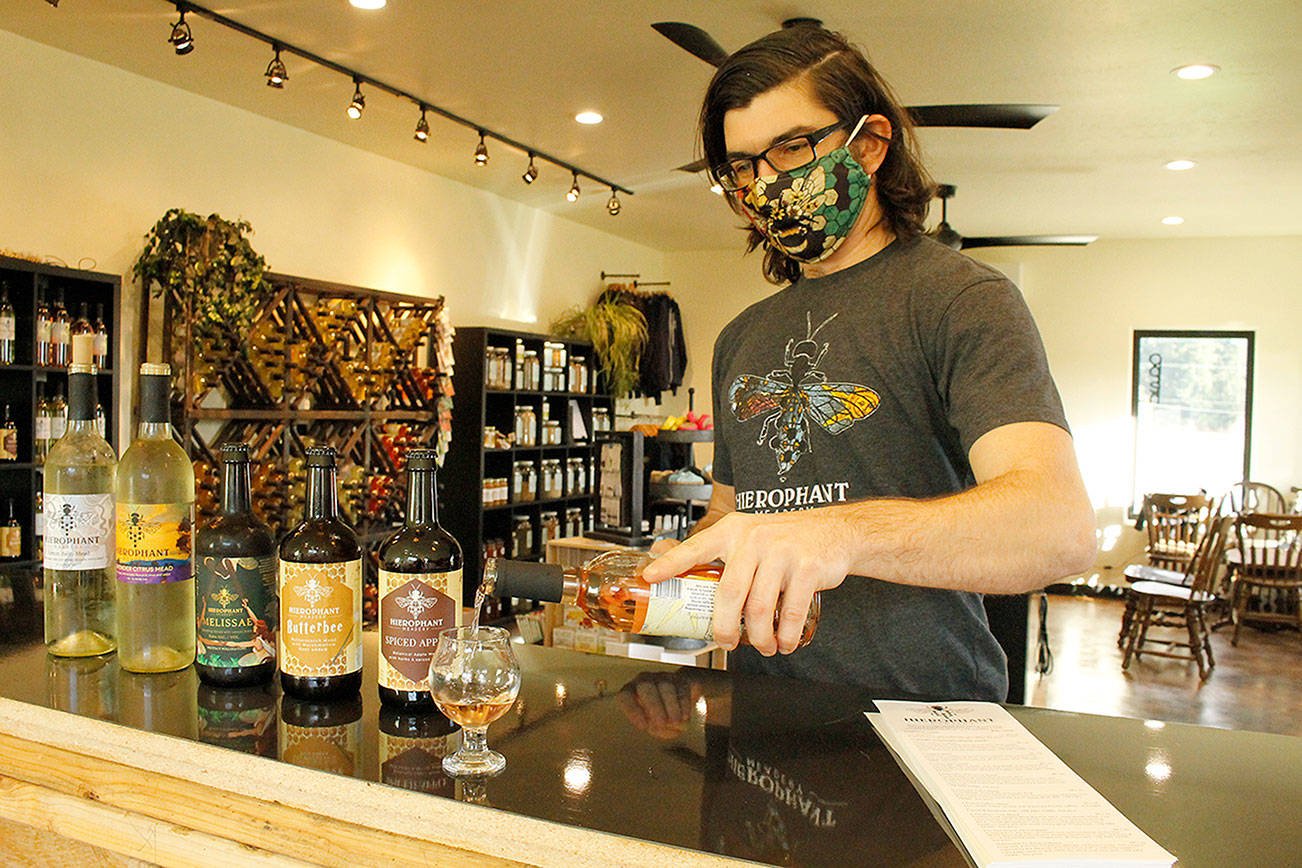Mead maker Jeremy Kyncl pours a tasting glass of Hawthorn Tulsi Mead, a blend of hawthorn berry and holy basil, in the new Whidbey tasting room of Hierophant Meadery. Photo by Kira Erickson/South Whidbey Record