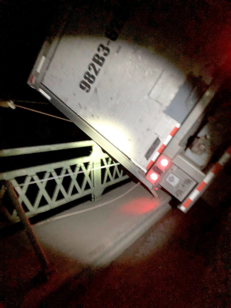 High wind gusts may have knocked over a truck onto the Highway 20 Deception Pass bridge railing early Wednesday morning. The truck was stuck for hours, but the driver safely escaped. (Washington State Department of Transportation)
