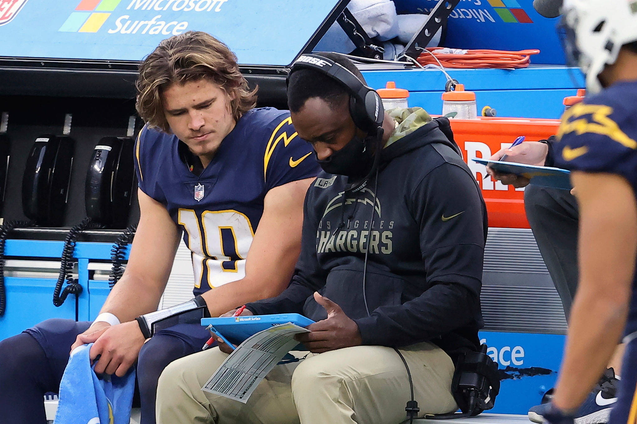 Chargers quarterback Justin Herbert (10) gets instruction from quarterbacks coach Pep Hamilton during a game against the Raiders on Nov. 8, 2020, in Inglewood, Calif. (AP Photo/Peter Joneleit)