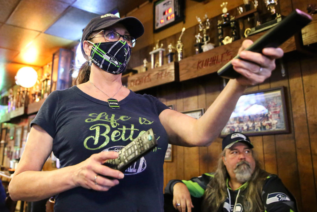 Tanya Buttke works the surround sound for a Seahawks game at Kuhnle’s Tavern in Marysville. (Kevin Clark / The Herald)
