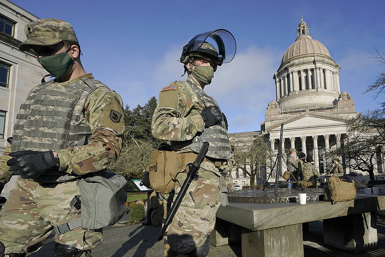 Members of the Washington National Guard stand at a sundial near the Legislative Building, Sunday, Jan. 10, 2021, at the Capitol in Olympia, Wash. Governors in some states have called out the National Guard, declared states of emergency and closed their capitols over concerns about potentially violent protests. Though details remain murky, demonstrations are expected at state capitols beginning Sunday and leading up to President-elect Joe Biden's inauguration on Wednesday. (AP Photo/Ted S. Warren)