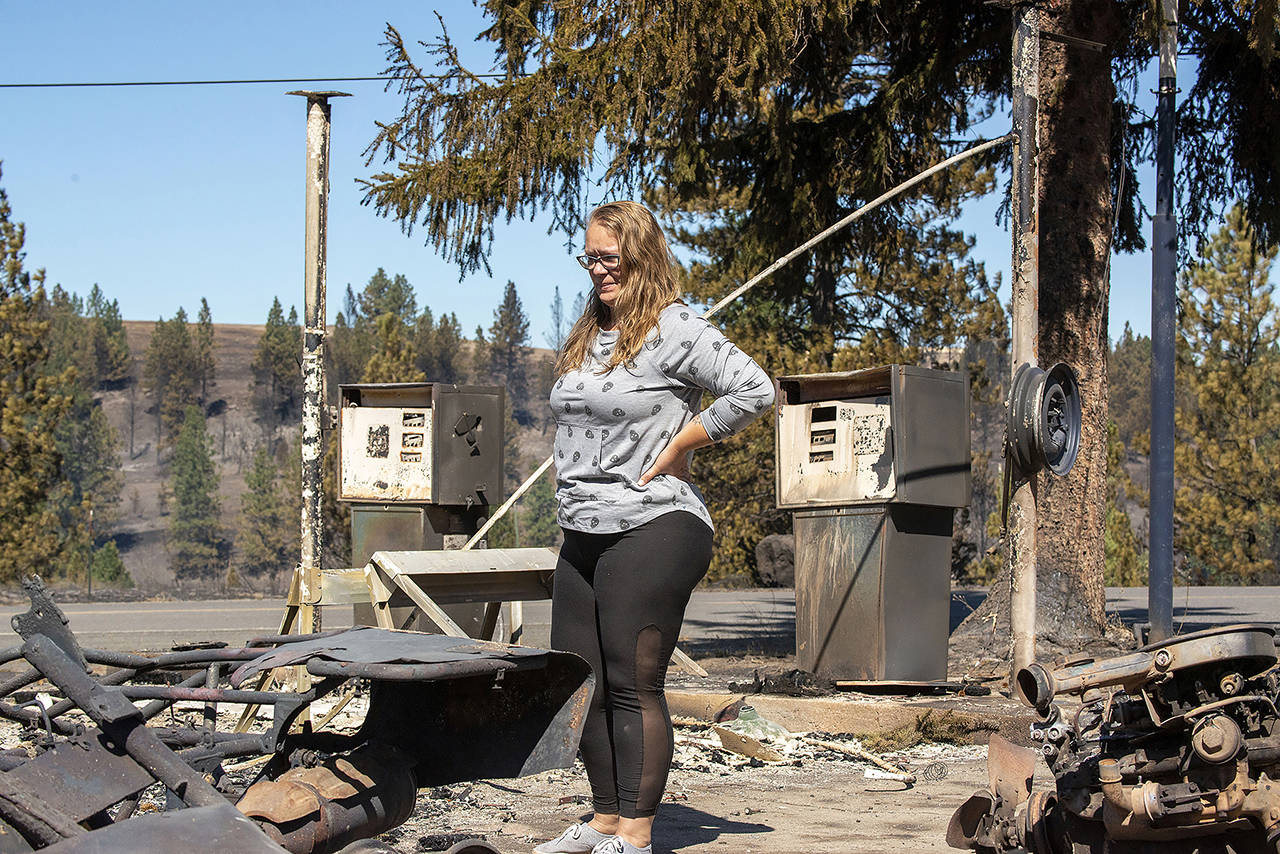 On Sept. 8, 2020, Hollie Jordan surveys her father’s service station that was destroyed by a wildland fire that blazed through the town of Malden a day earlier. (AP Photo/Jed Conklin)
