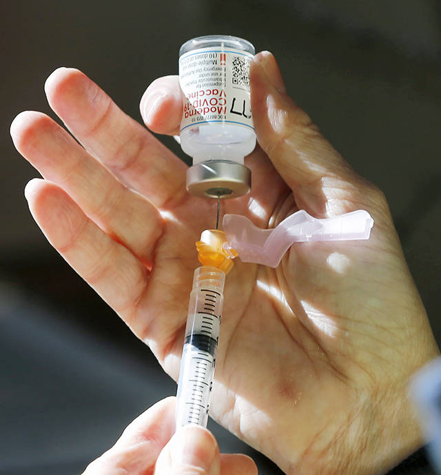 Syringes are filled with the Moderna COVID-19 vaccine for high-risk workers in Virginia on Tuesday. (Joe Mahoney/Richmond Times-Dispatch via AP)