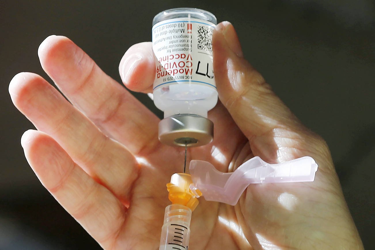 Syringes are filled with the Moderna COVID-19 vaccine during the first Phase 2 vaccination for Richmond and Henrico, Va., workers in high-risk professions during a Henrico County Health Department event at Richmond Raceway in Richmond, Va., Tuesday, Jan. 19, 2021. ( Joe Mahoney/Richmond Times-Dispatch via AP)