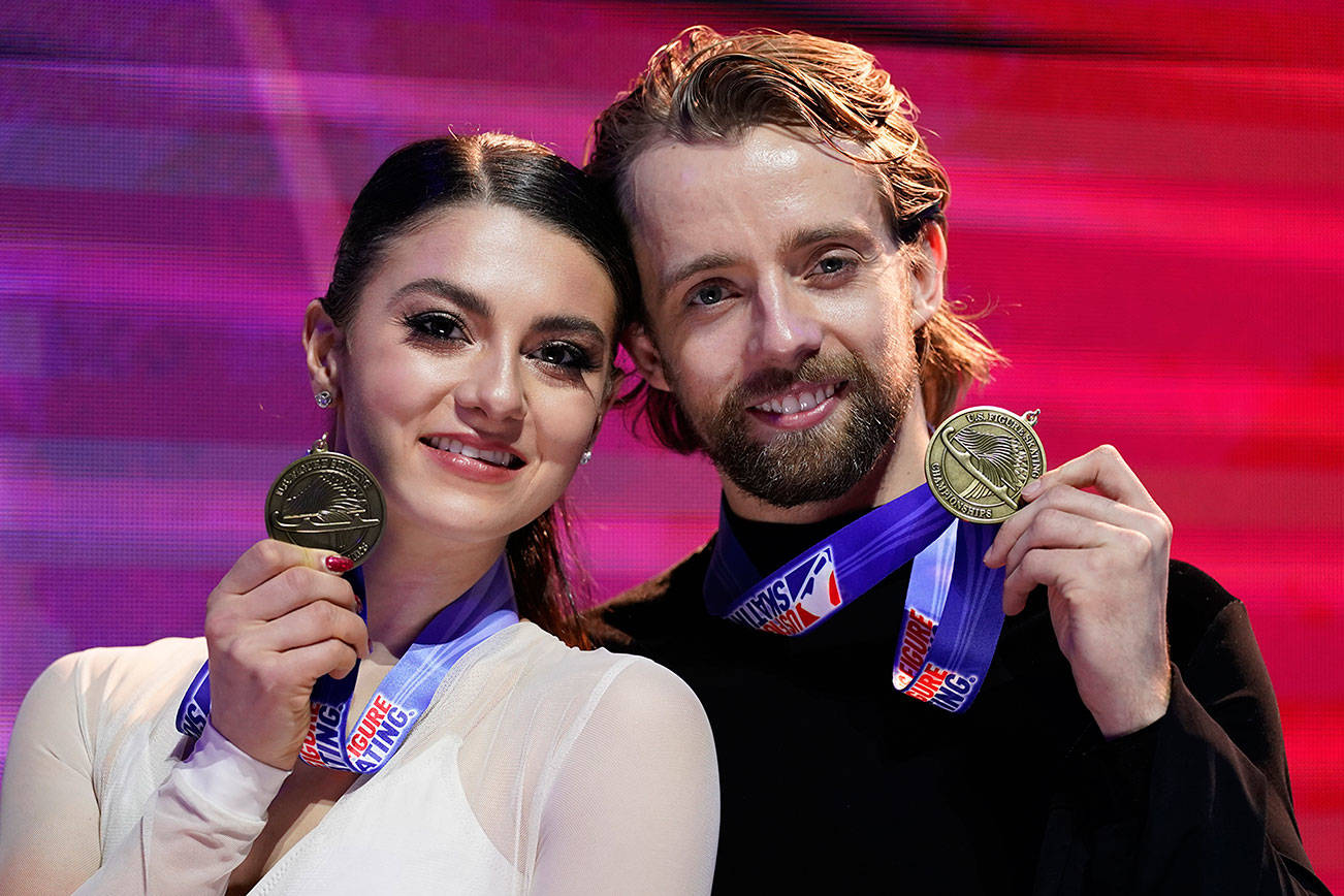 Third-place finishers Kaitlin Hawayek and Jean-Luc Baker pose with their medals in the championship ice dance at the U.S. Figure Skating Championships, Saturday, Jan. 16, 2021, in Las Vegas. (AP Photo/John Locher)