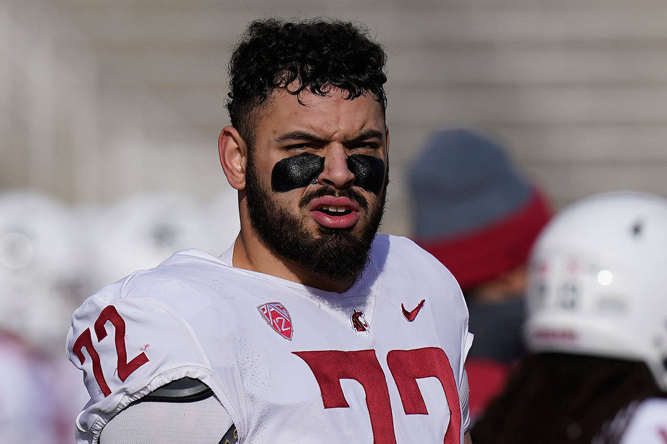 Washington State offensive lineman Abraham Lucas (72) looks on during the first half of an NCAA college football game against Utah Saturday, Dec. 19, 2020, in Salt Lake City. (AP Photo/Rick Bowmer)