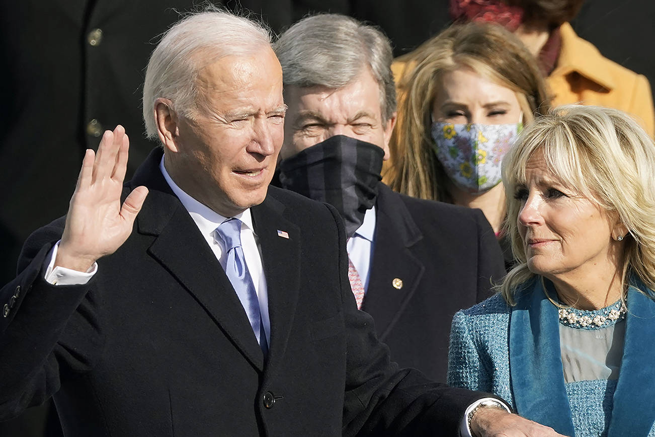 Joe Biden is sworn in as the 46th president of the United States by Chief Justice John Roberts as Jill Biden holds the Bible during the 59th Presidential Inauguration at the U.S. Capitol in Washington, Wednesday, Jan. 20, 2021. (AP Photo/Andrew Harnik)