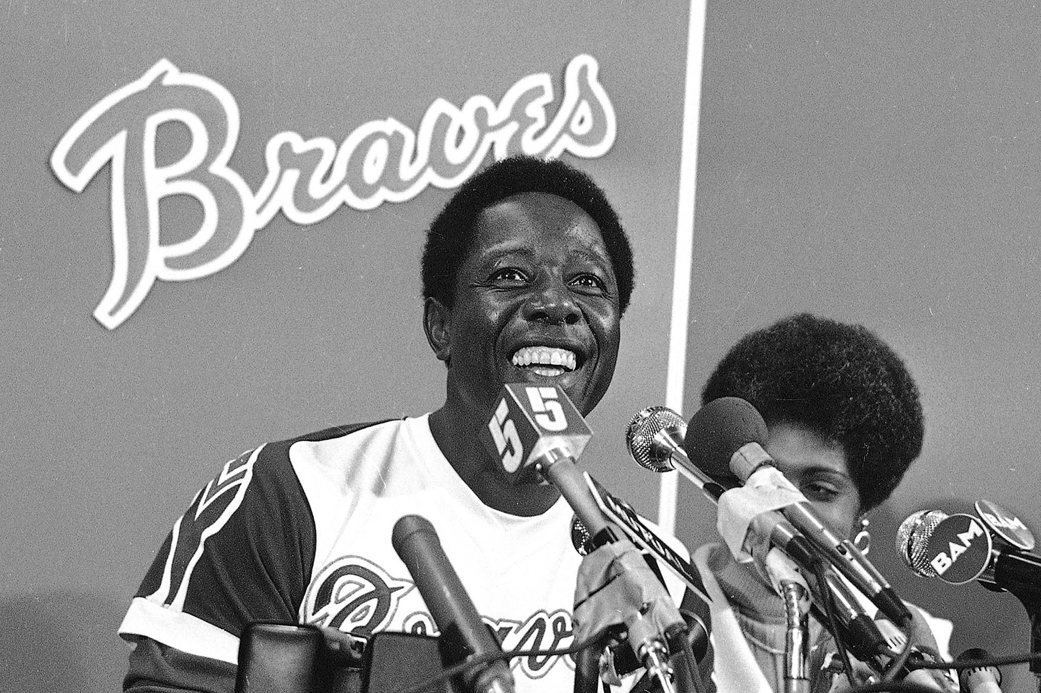The Braves’ Hank Aaron smiles during a press conference after the game in which he hit his 715th career home, in this April 8, 1974, file photo. Aaron, one of baseball’s greatest all-around players, died Friday. He was 86. (AP Photo/File)