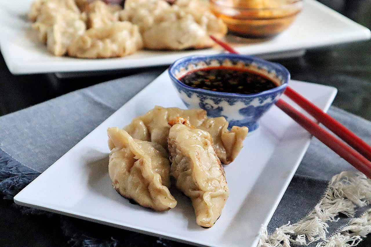Homemade pot stickers are filled with seasoned ground pork and served with a garlicky dipping sauce. (Gretchen McKay / Pittsburgh Post-Gazette)
