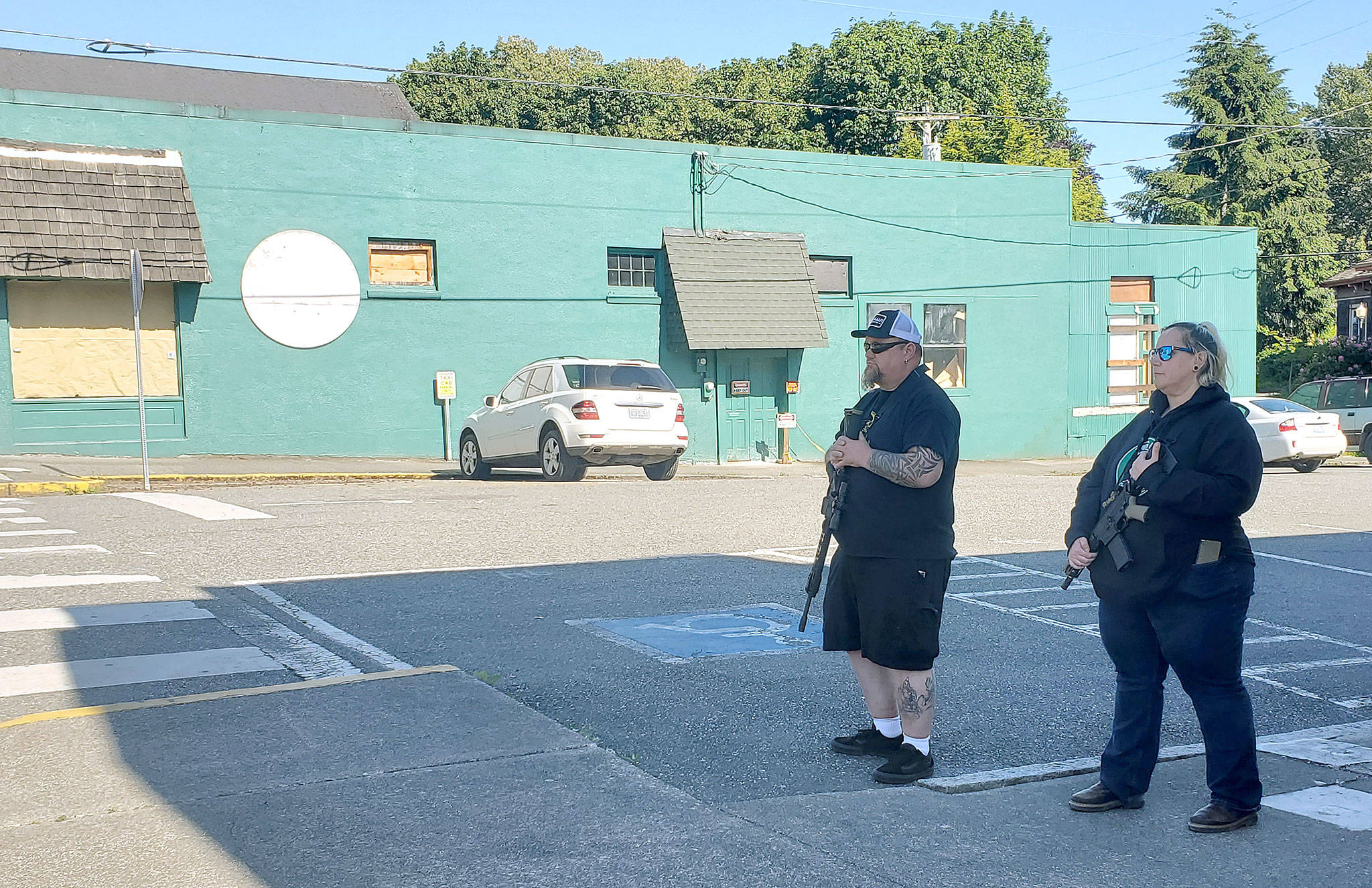 Armed citizens stand vigil in Snohomish on June 1 following a hoax that threatened businesses with vandalism and looting. Declinging to identifying themselves, the man said they were there to “keep business owners and businesses safe. We don’t need our little town torn apart.” (Ian Davis-Leonard / Herald file photo)