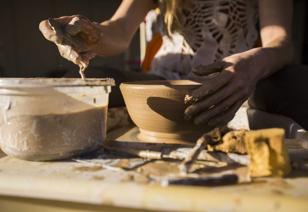 Rachel Recker at work on a bowl at Salish Sea Ceramics in Everett. (Olivia Vanni / The Herald) 
