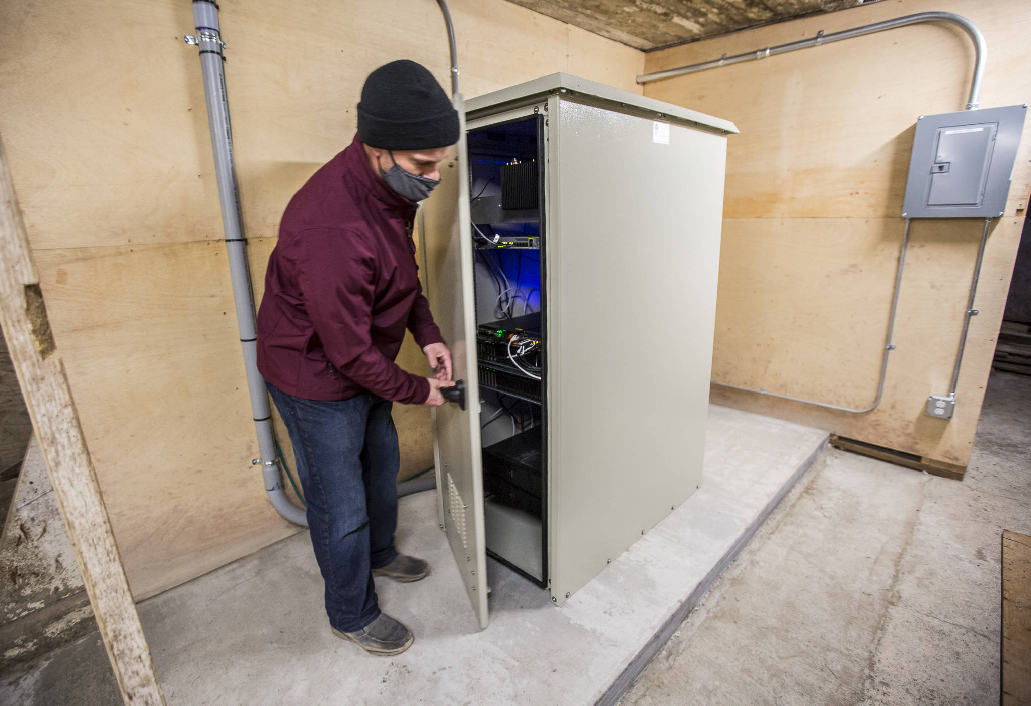 Nate Krause, owner of Swans Trail Farms, opens the data center housed in a barn in Snohomish. (Olivia Vanni / The Herald)