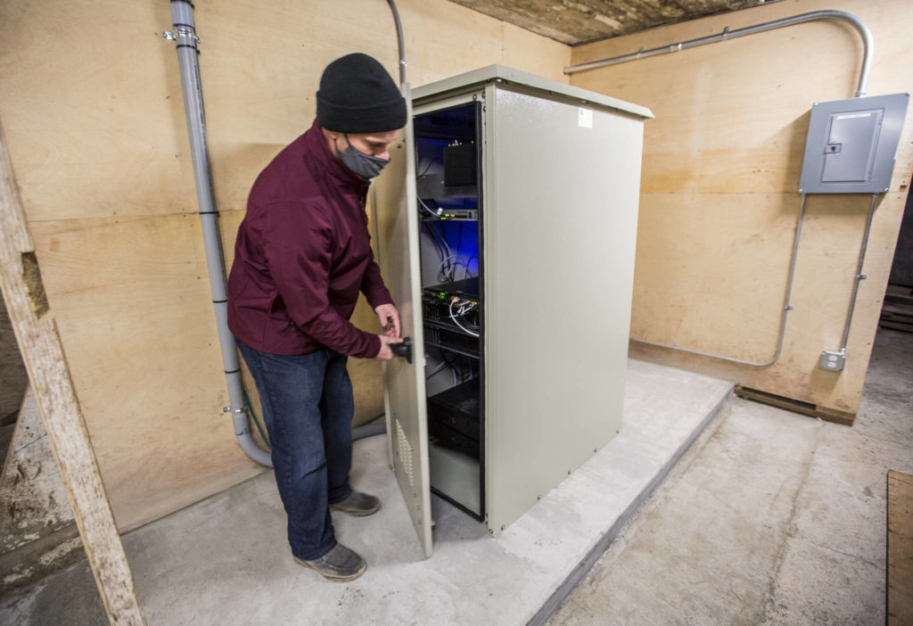 Nate Krause, owner of Swans Trail Farms, opens the data center housed in a barn in Snohomish. (Olivia Vanni / The Herald)
