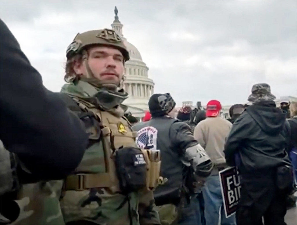 From video, Robert Gieswein (left, in fatigues) at the U.S. Capitol before it was stormed by rioters on Jan. 6 in Washington, D.C. 
