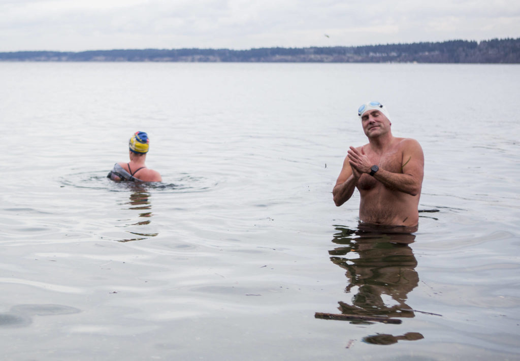 Joe Hempel (right), and Kristin Galbreaith finish their 35-minute, one-mile swim from Seawall Park in Langley. (Olivia Vanni / The Herald)
