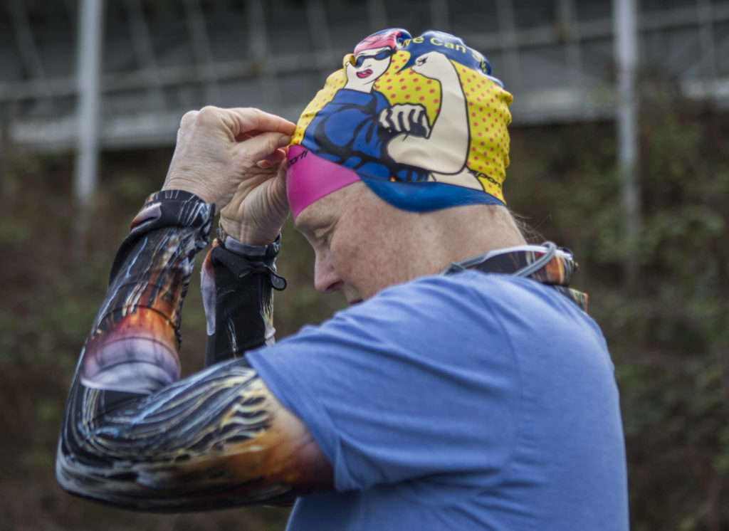 Kristin Galbreaith puts on a Rosie the Riveter swim cap before her swim. (Olivia Vanni / The Herald)
