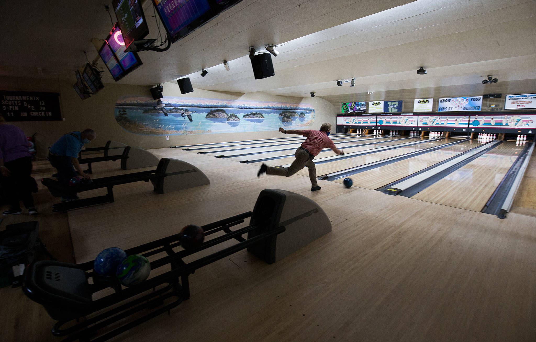 Dennis Shewey, of Arlington, bowls at Evergreen Lanes on Monday in Everett. Starting Monday, certain categories of Snohomish county businesses were permitted to reinstate indoor occupancy at 25% capacity under Phase 2 of Gov. Jay Inslee’s statewide reopening plan. (Andy Bronson / The Herald)