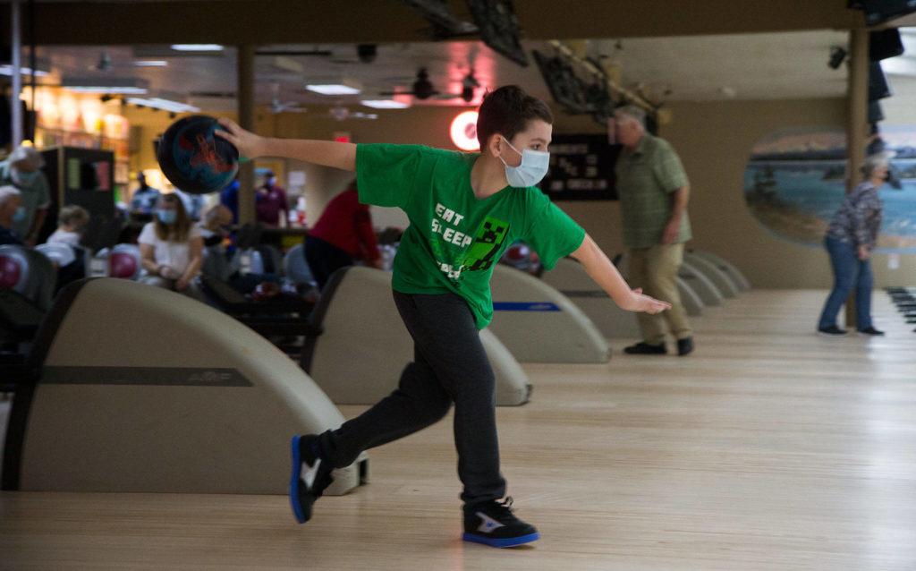 Jake Sale, 10, winds up for the toss as he bowls at Evergreen Lanes on Monday in Everett. (Andy Bronson / The Herald)
