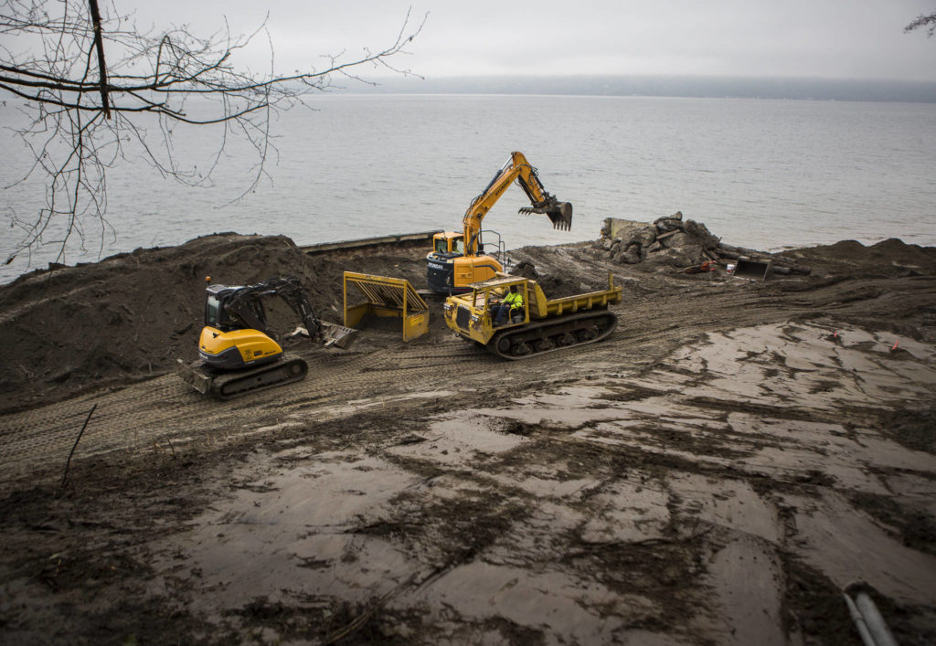 Dirt is sorted for debris and large rocks during the deconstruction of a seawall north of Langley. (Olivia Vanni / The Herald)
