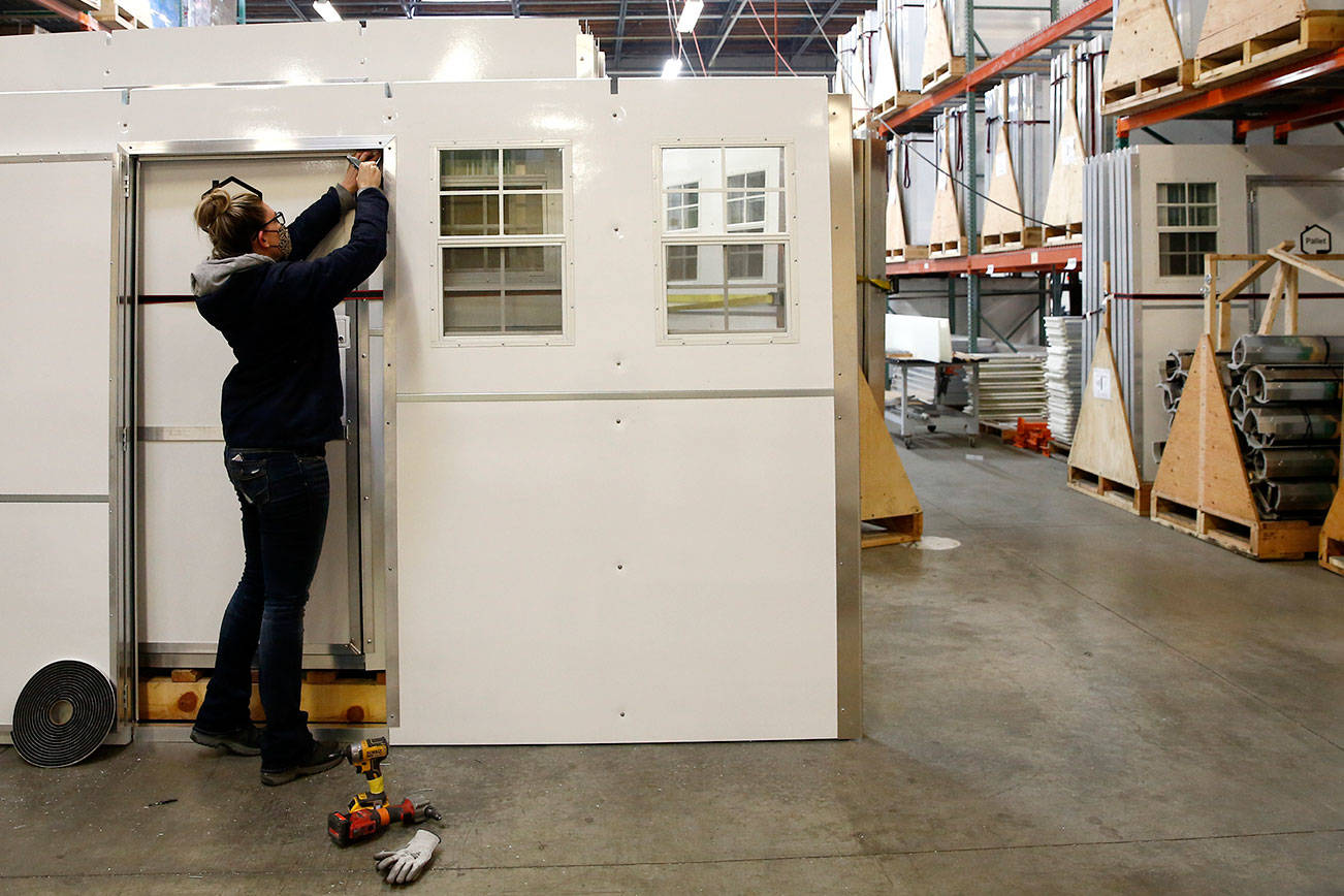 Weatherstripping is installed Thursday afternoon at Pallet in Everett on January 21, 2020. (Kevin Clark/The Herald)