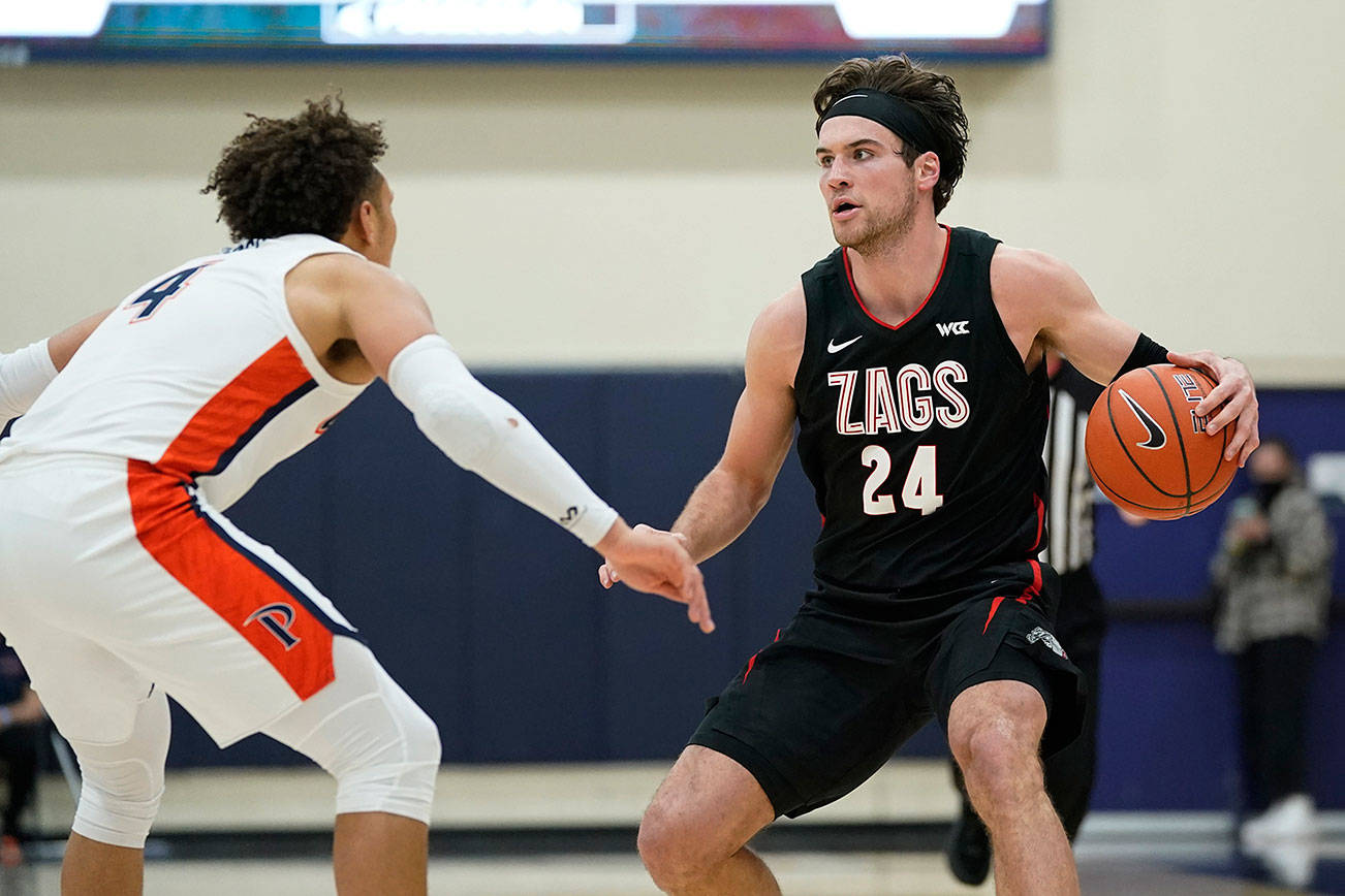 Pepperdine guard Colbey Ross (4) defends against Gonzaga forward Corey Kispert (24) during the second half of an NCAA college basketball game Saturday, Jan. 30, 2021, in Malibu, Calif. (AP Photo/Ashley Landis)