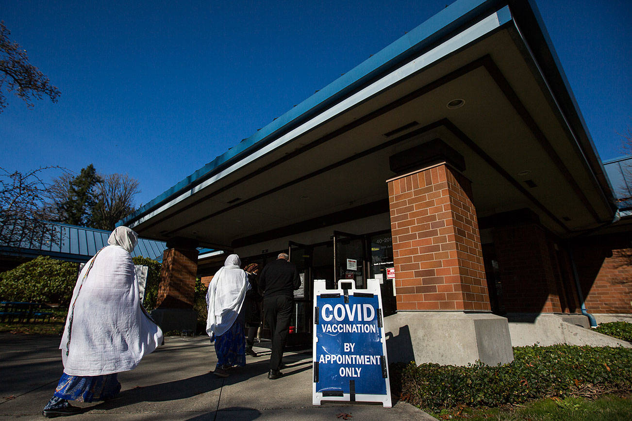 People walk into the new Boeing Activity Center COVID-19 vaccination site on Wednesday, Feb. 3, 2020 in Everett, Wa. (Olivia Vanni / The Herald)