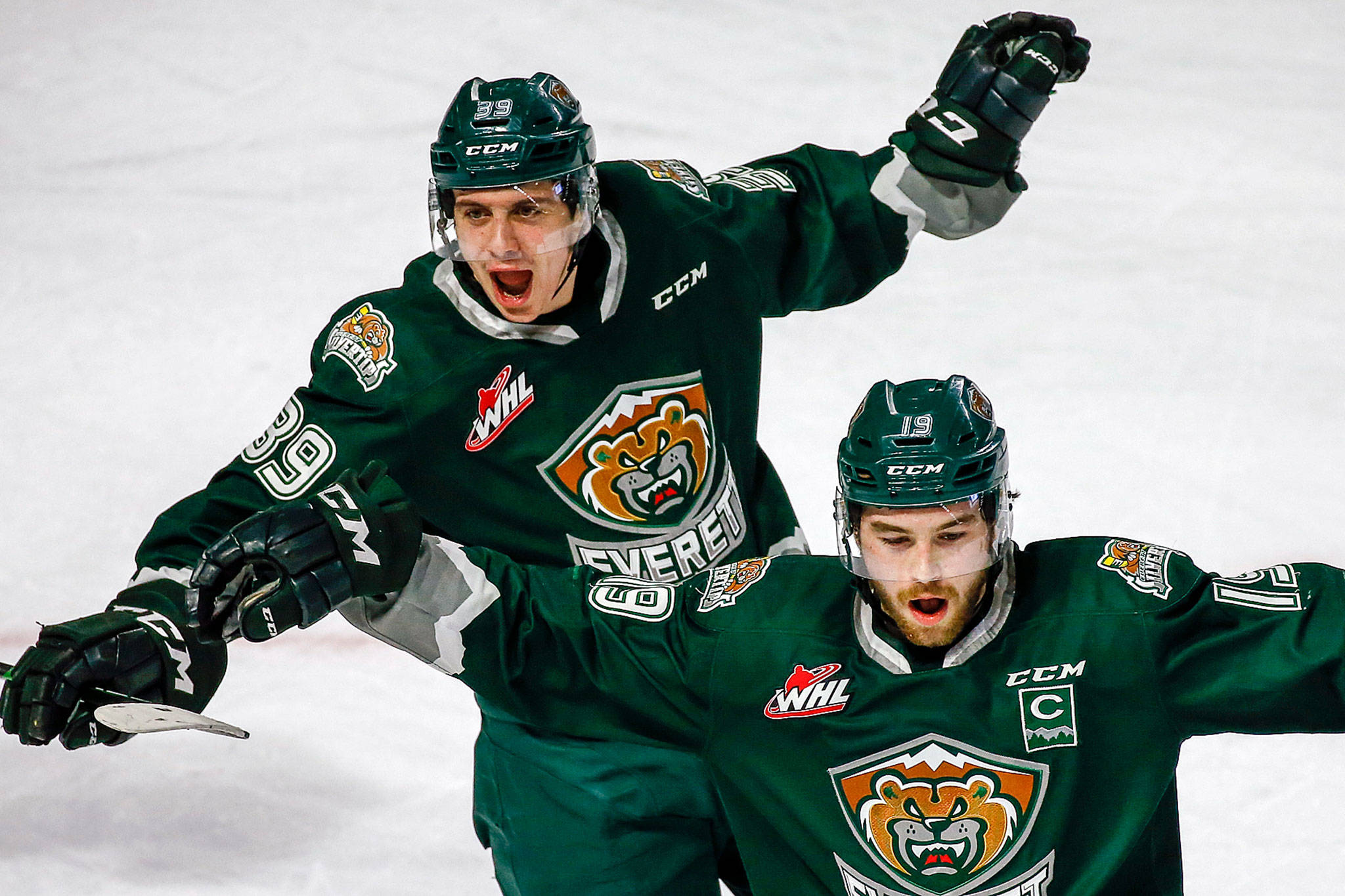 The Silvertips’ Gage Goncalves (left) and Bryce Kindopp celebrate a goal during a game against the Thunderbirds on March 8, 2020, at ShoWare Center in Kent. (Kevin Clark / The Herald)