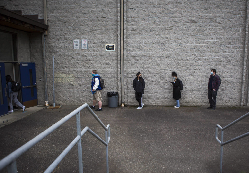Students line up, social distanced, before entering Sultan High School on Thursday. (Olivia Vanni / The Herald) 
