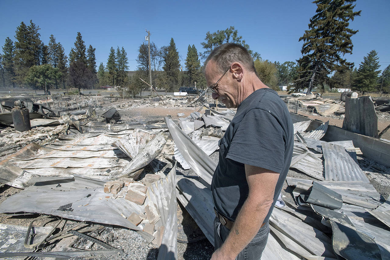 Jim Murray, 59, surveys his house that was destroyed by a wildfire on Sept. 8, 2020, in Malden, Washington. (AP Photo/Jed Conklin, file)