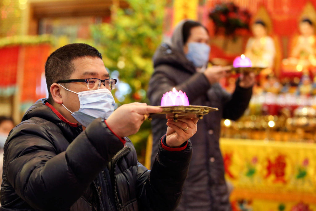 People gathered to offer prayers and wishes for Lunar New Year at Dia Tang Temple in Lynnwood on Friday. (Kevin Clark / The Herald)
