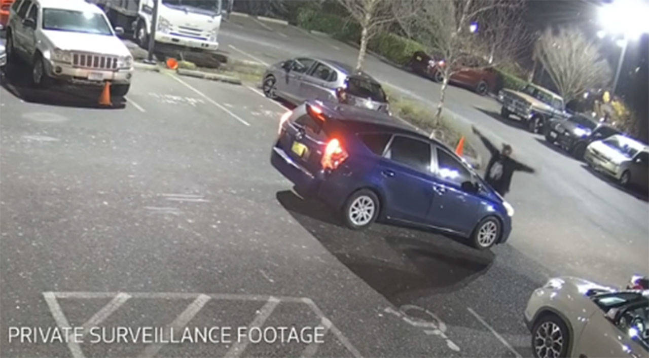 A screenshot from private surveillance footage shows the suspect engaging with the occupants of the vehicle on Feb. 9 in Seattle. (Seattle Police Department)