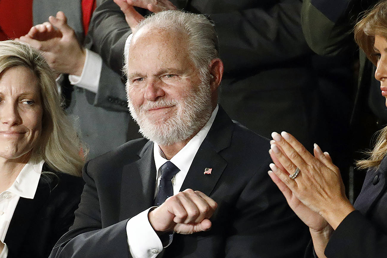 FILE - In this Feb. 4, 2020 file photo, Rush Limbaugh reacts as first Lady Melania Trump, and his wife Kathryn, applaud, as President Donald Trump delivers his State of the Union address to a joint session of Congress on Capitol Hill in Washington.  Limbaugh, the talk radio host who became the voice of American conservatism, has died. (AP Photo/Patrick Semansky, File)