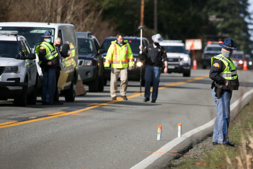 Washington State Patrol officers examine the scene of a hit and run double fatality in Bothell Friday on February 19, 2021. (Kevin Clark / The Herald)
