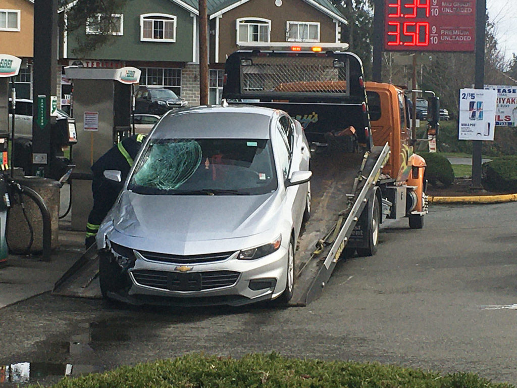 A suspect’s car is towed from the scene near a fatal hit and run Friday north of Bothell. (Kevin Clark / The Herald)
