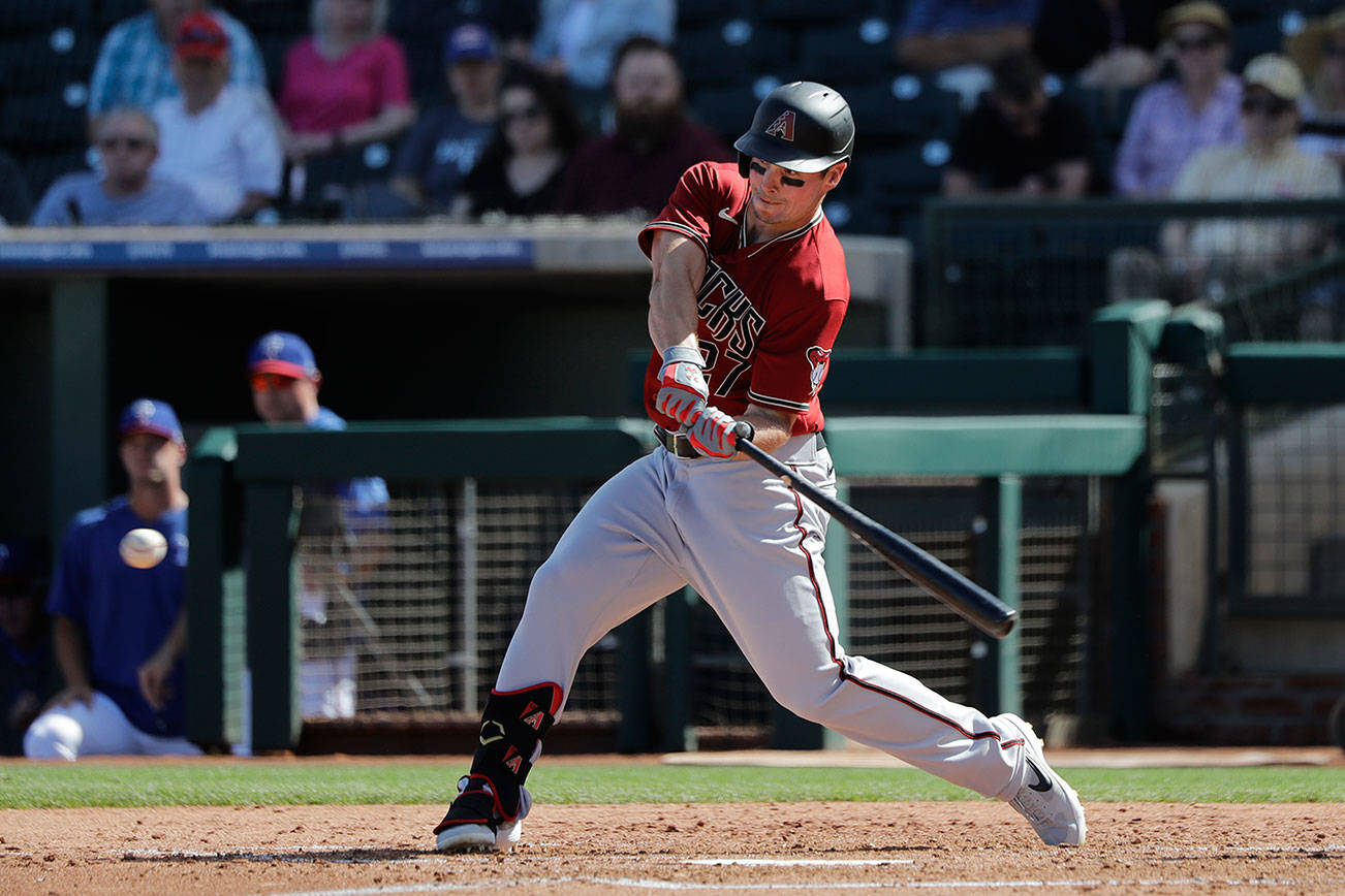 Arizona Diamondbacks' Travis Snider singles against the Texas Rangers during a spring training baseball game Thursday, March 5, 2020, in Surprise, Ariz. (AP Photo/Elaine Thompson)