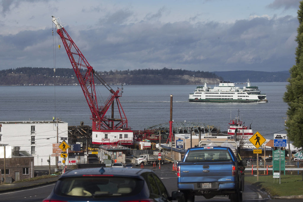 A ferry passes by the remains of the Mukilteo ferry dock ramp and pier on Tuesday. (Andy Bronson / The Herald)
