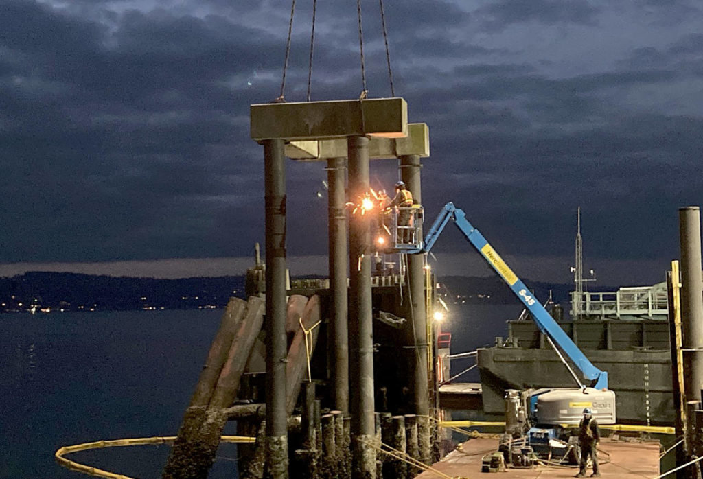 Crews cut and remove the west concrete pile cap during the demolition of the transfer span and decking at the old Mukilteo ferry dock. (Washington State Department of Transportation)
