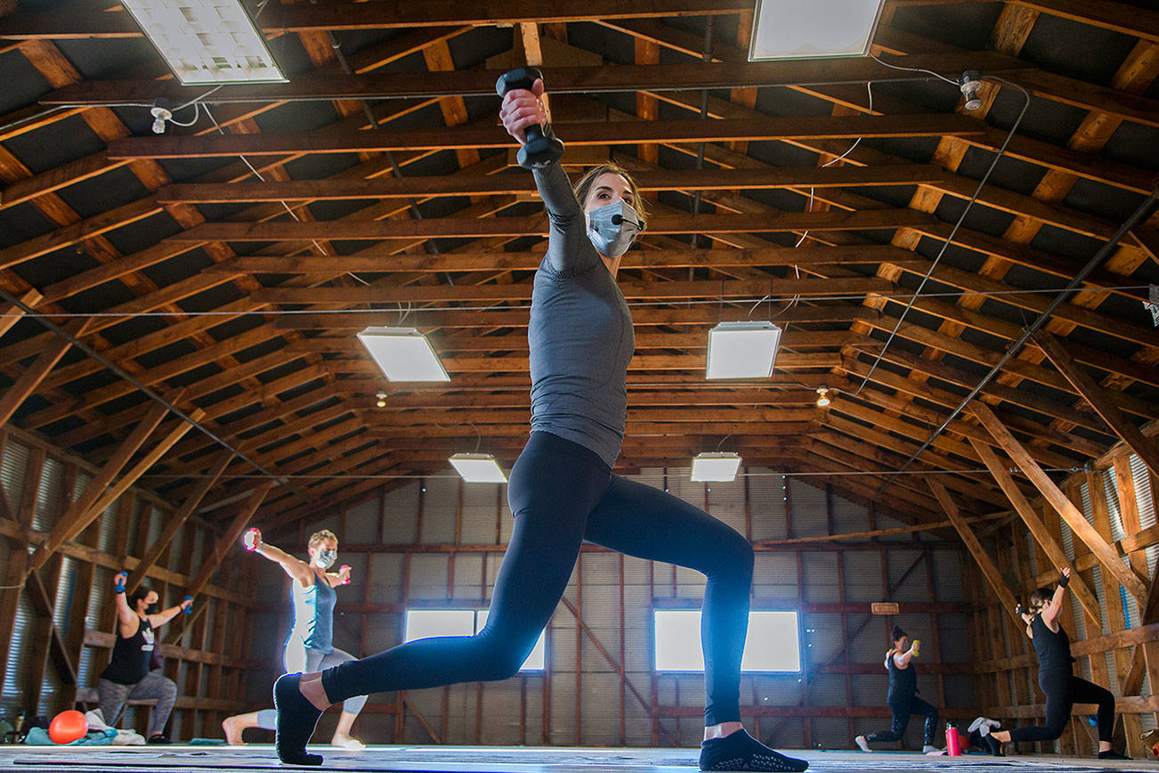Barre3 owner Gina Drake leads an exercise class in the Red Barn at 5th Ave S and Maple Street on Wednesday, Jan. 13, 2020 in Edmonds, Washington.  (Andy Bronson / The Herald)