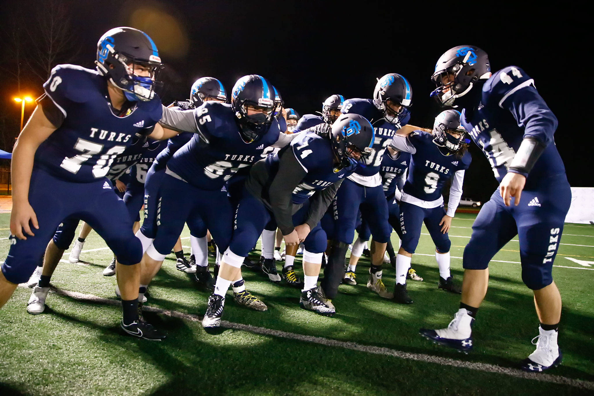 The Sultan High School football team gets fired up before its annual Black and Blue Bowl rivalry game against Granite Falls on Friday night. It marked the first Snohomish County prep football game in more than 15 months. (Kevin Clark / The Herald)