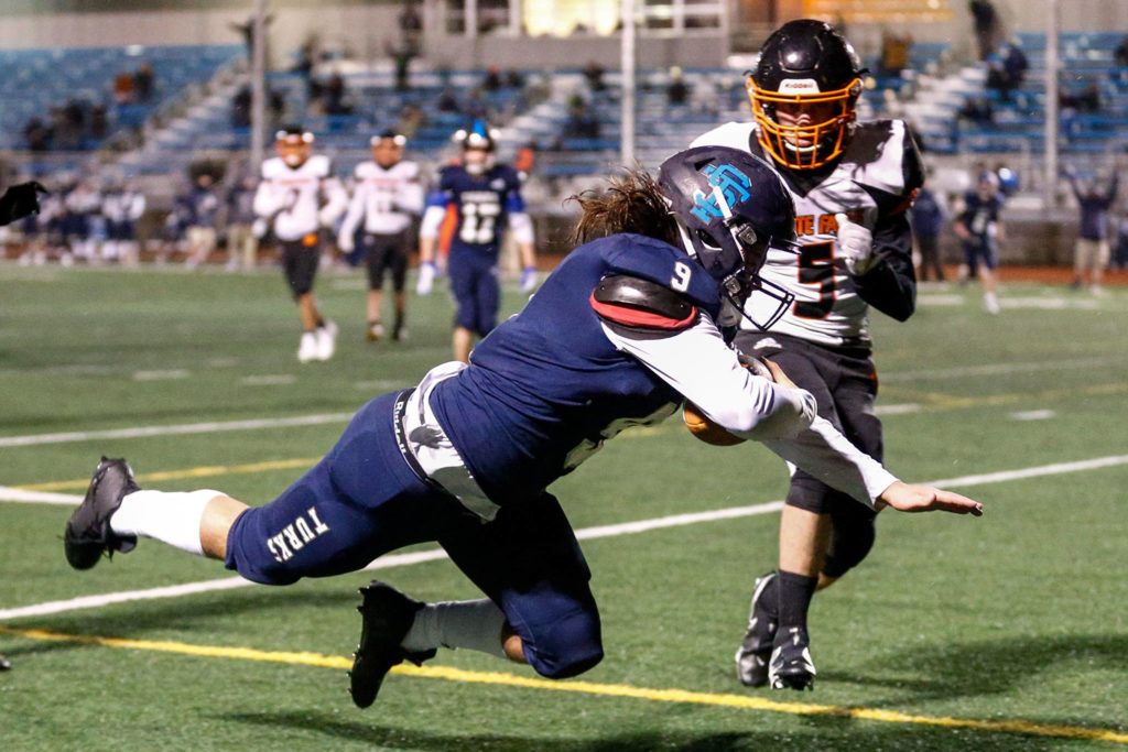 Sultan’s Zane Sailor scores a touchdown with Granite Falls’ Jace Stevens looking on Friday night in Sultan on February 26, 2021 (Kevin Clark / The Herald)
